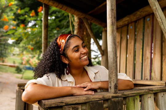 Young Woman Resting on a Wooden Garden Gazebo