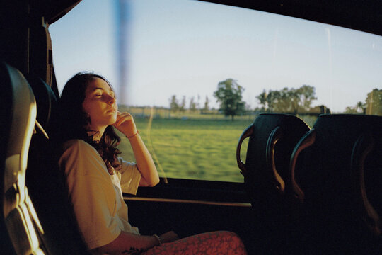 Woman traveling by bus through rural Australia 