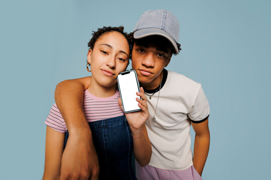 Friends showing smartphone with blank screen