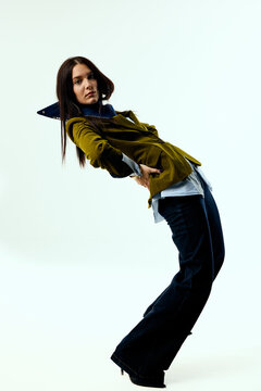 Woman in contemporary clothing posing in a studio