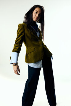 Modern woman wearing sophisticated clothes in studio