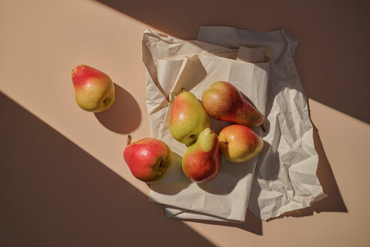 Still life composition with pears on wrinkled paper