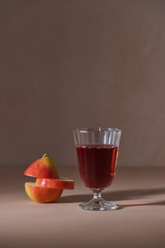 Delicious pear juice in a glass, served with cut pears