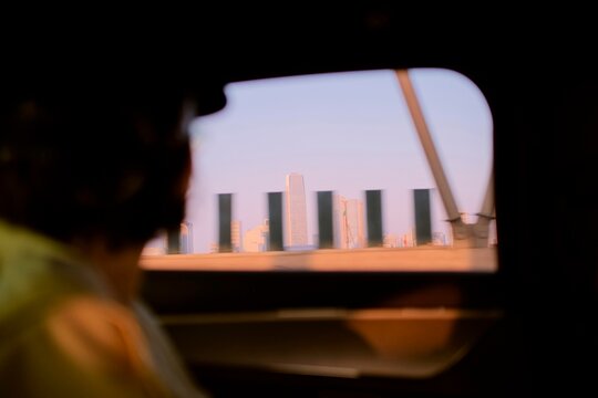 View of City Skyline From a Moving Vehicle in the Evening Light