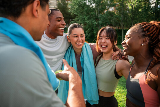 Group of friends laughing together in a park