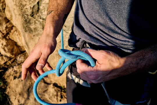 Anonymous man prepares for a rock climb