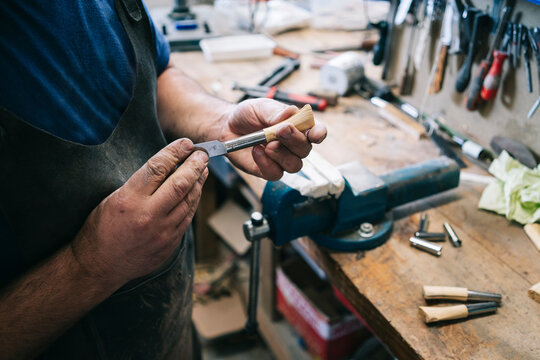 Craftsman making a knife handle in workshop