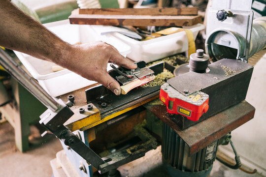 Craftsman shaping knife handle in the workshop