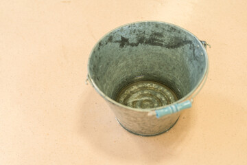 Tin buckets and aluminum buckets on the floor © buritora