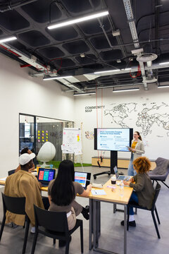 Diverse team brainstorms in modern office meeting