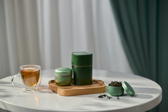 A beautifully arranged scene with tea, canisters, and a cup on table