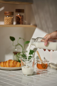 A simple morning scene: milk being poured into a glass