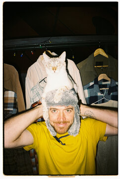 Analog. fun Man Holds Cat on Head 