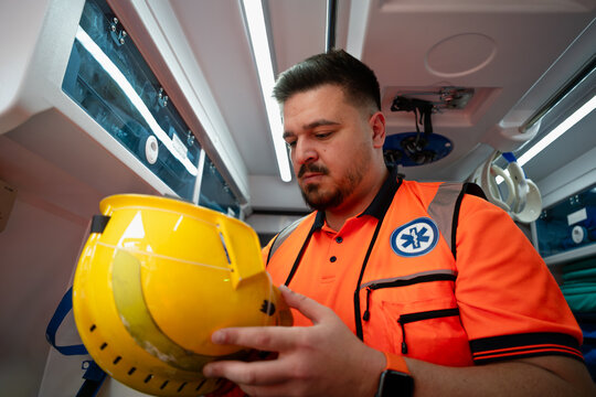 Paramedic Checking Emergency Helmet