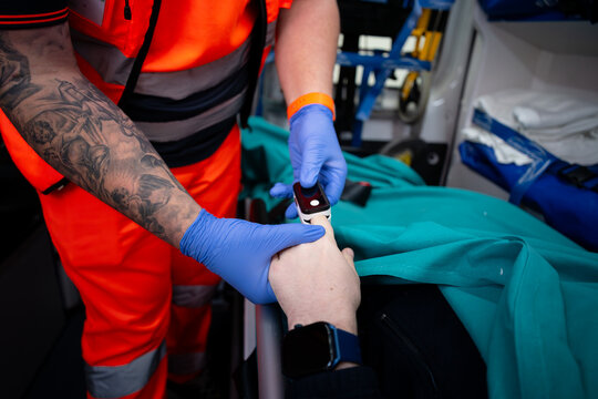 Paramedic Monitoring Patient Oxygen