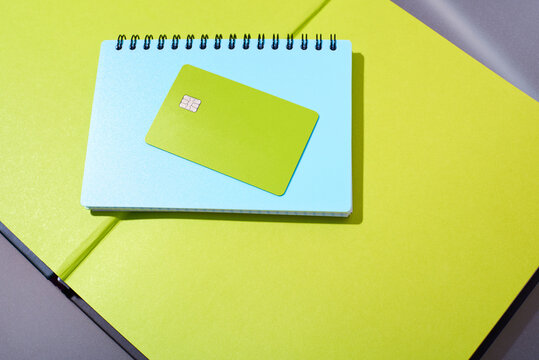 Notebook and card laying on a bright surface
