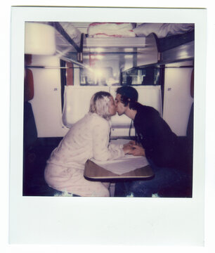 Vintage Polaroid of Newlywed Couple Kissing in Train Compartment