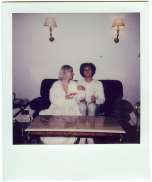 Vintage Polaroid of Newlyweds Relaxing in Hotel Room After Wedding