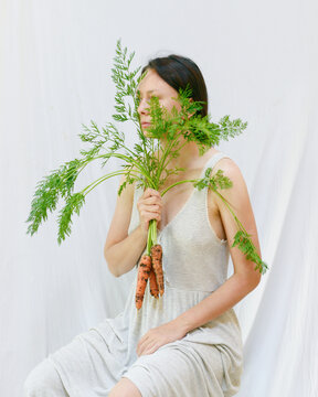 Woman holding fresh carrots