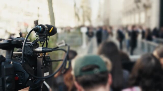 Professional video camera filming a crowded event