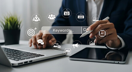 Fototapeta premium Professional business person using digital search interface with marketing icons on a modern office desk with laptop and tablet for strategic online seo planning