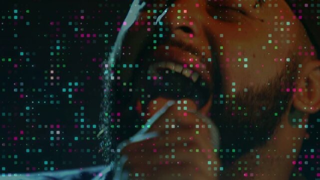 Cutting to closeup, singer singing, getting loud while tuning mic for recording under pixel overlay