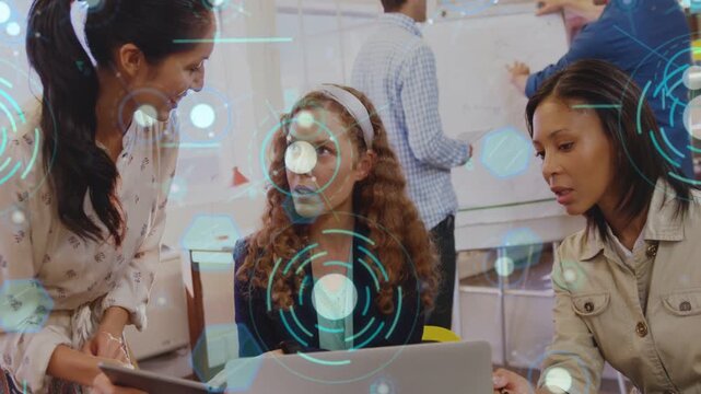 Woman showing tablet team leaning on laptop holo animating over team reaching business consensus