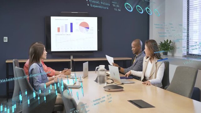 Presenter standing and pointing, team taking notes reviewing finance charts as AR overlay updating