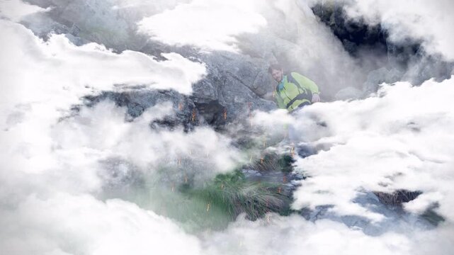 Hiker emerging as cloud overlay parts, stepping down rocky path with ember sparks for travel ad