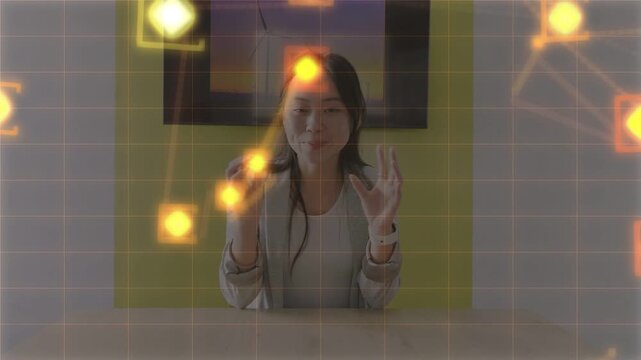 Woman holding round object, miming interaction with grid and particles appearing during tech demo