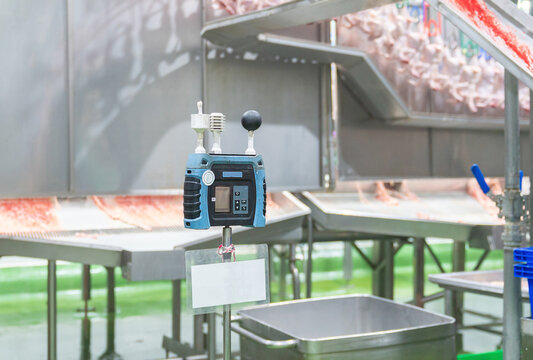 Electronic heat stress monitor and environmental sensing device installed in a food processing plant or slaughterhouse to ensure occupational health and safety standards for workers.