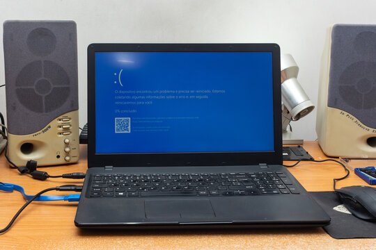 S&atilde;o Paulo, SP, Brazil - April 17th, 2026: Blue Screen of Death - BSOD of the Windows on a laptop that has already been opened for bench maintenance.