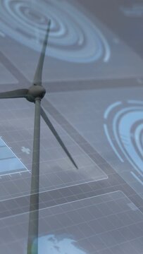 Vertical video: Moderate wind starting turbine blades rotating for energy, overlay showing grid map