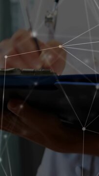 Vertical video: Nurse gripping pen writing on clipboard, network overlay showing medical records