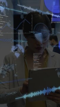 Vertical video: Woman using tablet in hall tapping and analyzing graphs and data overlays over face