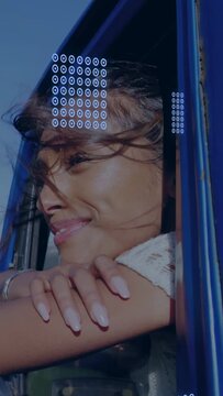 Vertical video: Woman leaning out window wind blowing hair viewing travel HUD appearing over face
