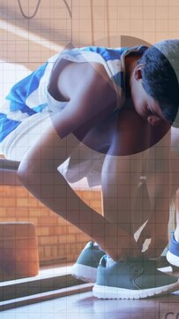 Vertical video: Boy seeing loose laces tying shoe on bench for sports with charts marking laces