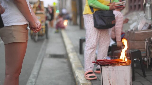Worshipper Praying with Candlelight Vendors in Background