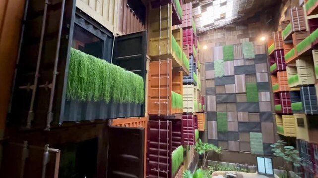 Modern industrial architecture video that uses stacks of used containers that are repurposed as hotel rooms and buildings.
