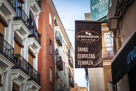 VALENCIA, SPAIN - APRIL 7, 2025: Street sign advertising tapas, cervezas illustrating Spanish hospitality, casual dining culture and the visual language of urban food tourism in a dense city street.