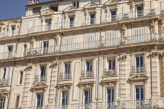 Typical Haussmann-style residential building in Marseille, France, from below, shuttered windows, illustrating real estate in marseille and classic French property architecture.
