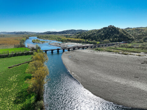 Aerial view of Fortezza di Verrua Savoia on a hill overlooking the Po River and a stone bridge under a clear blue sky Verrua Savoia, Piedmont, Italy.