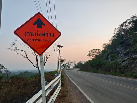 Rural road under construction heading towards the mountains in Khao Wong, Kalasin