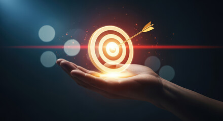 Fototapeta premium Hand Holding Target with Dart Hitting Bulls Eye Glowing Light Concept of Goal Setting Successful Strategy Reaching Achievement Opportunity Competition