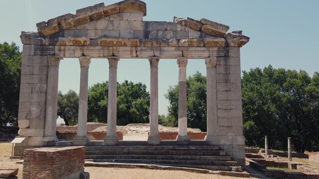 Historic Bouleuterion monument featuring majestic Corinthian columns, situated within the expansive archaeological park of Apollonia in Fier, Albania