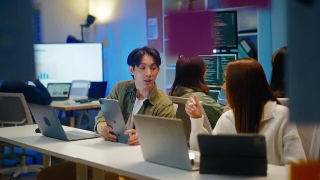 Asian software engineer or programmer team working late in development office,problem solving or algorithm of ai assistant helping for work.software developer,digital technology security concept