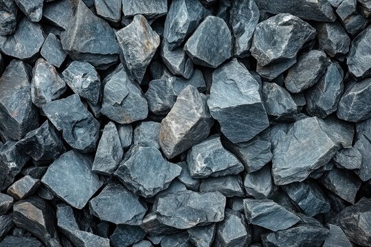 close-up of piled dark gray crushed stones with rough angular textures evoking a cool rugged mood