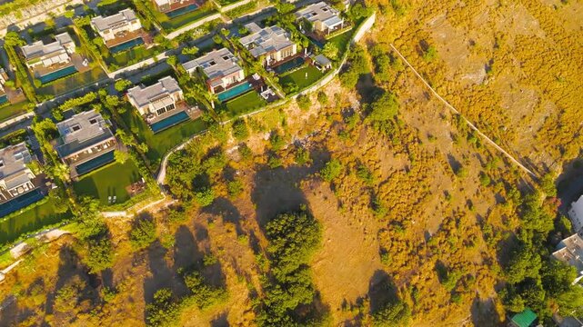 Bodrum, Turkey. Close aerial drone view of Bodrum windmills details. Stone walls and architectural features illuminated by morning sun.. Aerial View, MasterShots, Fly Forward - Roll, Tilt up