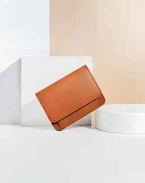 Beautiful tan leather wallet for women on a white and brown background, perfect for leather industry catalog design