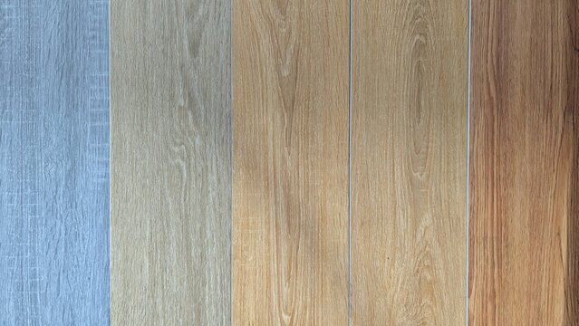 Various wood texture samples displayed in a supermarket, offered as options for flooring or wall panels, featuring natural grain patterns for home and interior building materials